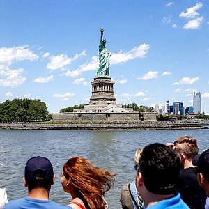 Visitors enjoying free views of the Statue of Liberty from a public ferry, showcasing one of the best alternatives to purchasing Liberty Island ferry tickets.