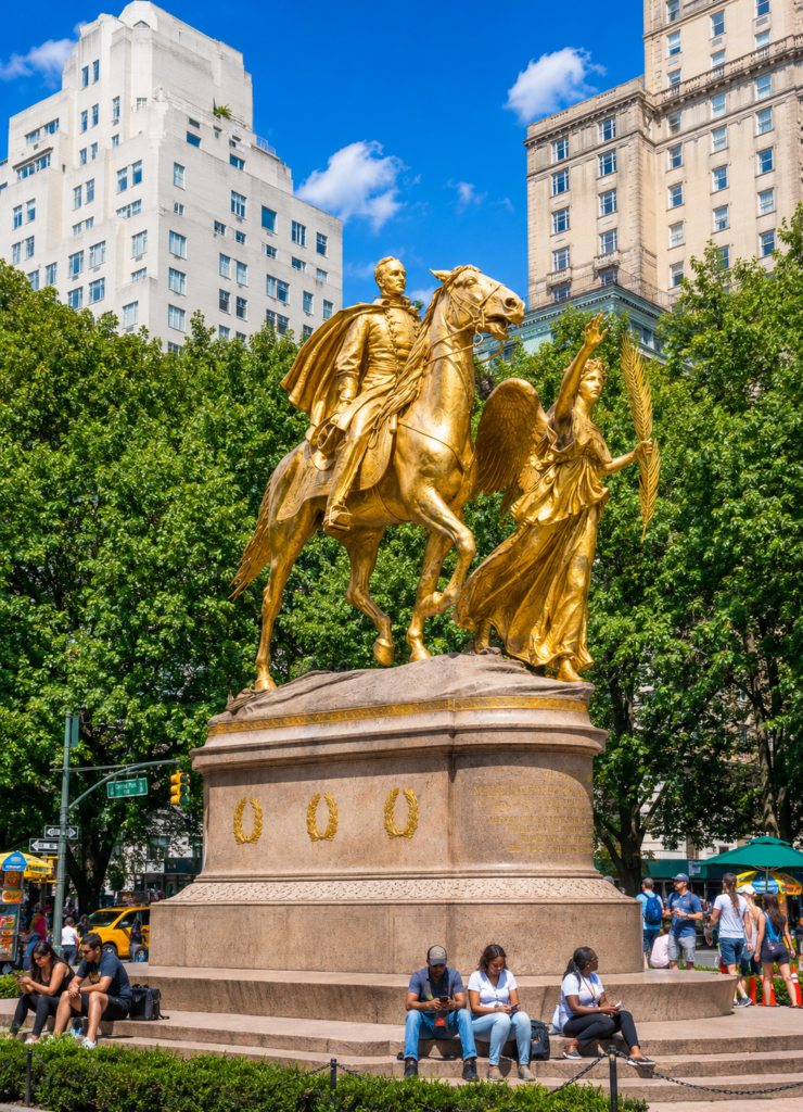 Grand Army Plaza in Central Park features the iconic gilded equestrian statue of General William Tecumseh Sherman, surrounded by lush trees, elegant architecture, and lively city streets.
